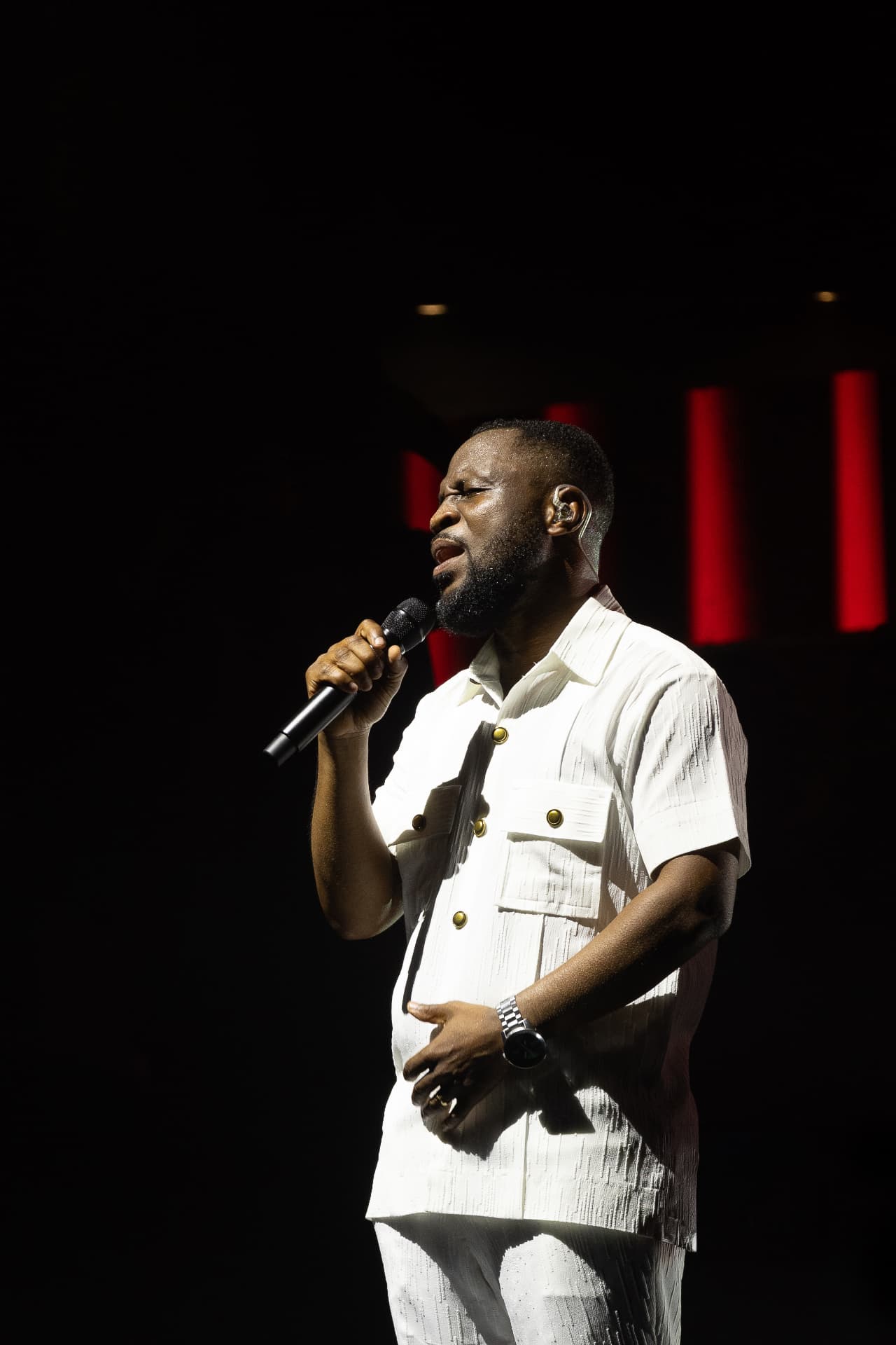Pastor Edwin Dadson singing and looking upward during live worship